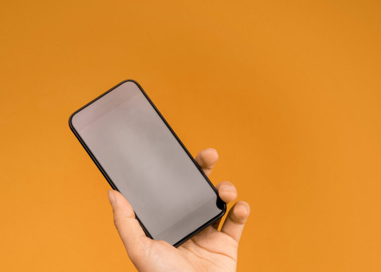 phone on orange background, ADHD Evaluations for Children and Adults in McKinney, TX
