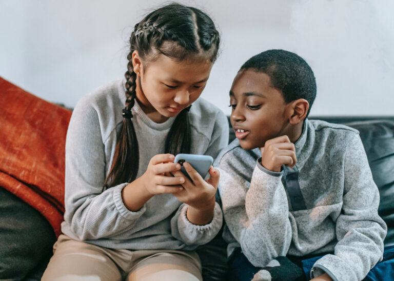 multiracial kids looking at phone, ADHD testing, McKinney, TX